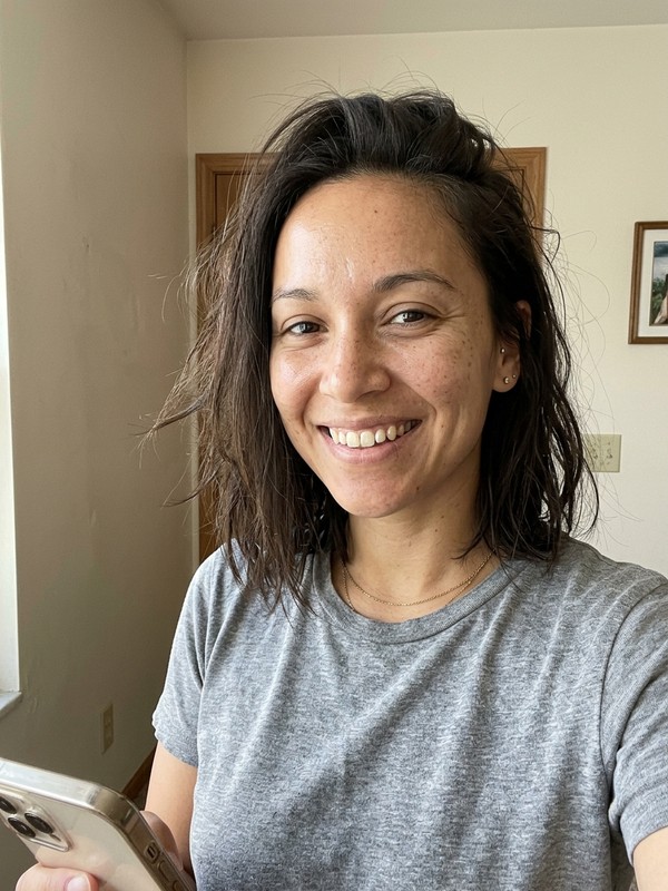 Before - an ordinary phone selfie of the same woman with no editing